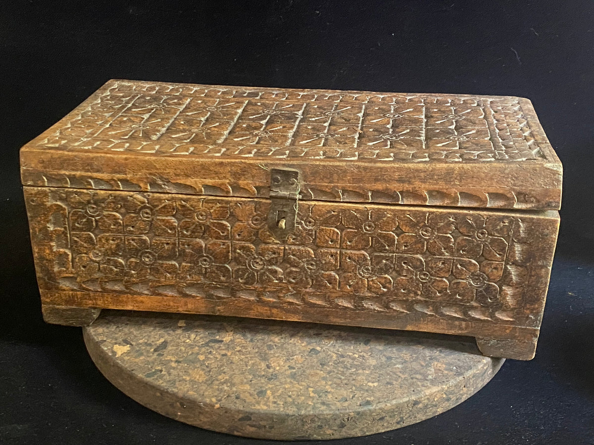 A lovely old Indian box, fully carved on all sides including the back. Made from teak. This would make a lovely trinket box, key box, jewellery, watch or cufflink box. Circa 1880 - 1920. Handmade in southern India. Measurements: length 30.5 cm&nbsp; x depth 15 cm, height 12 cm.