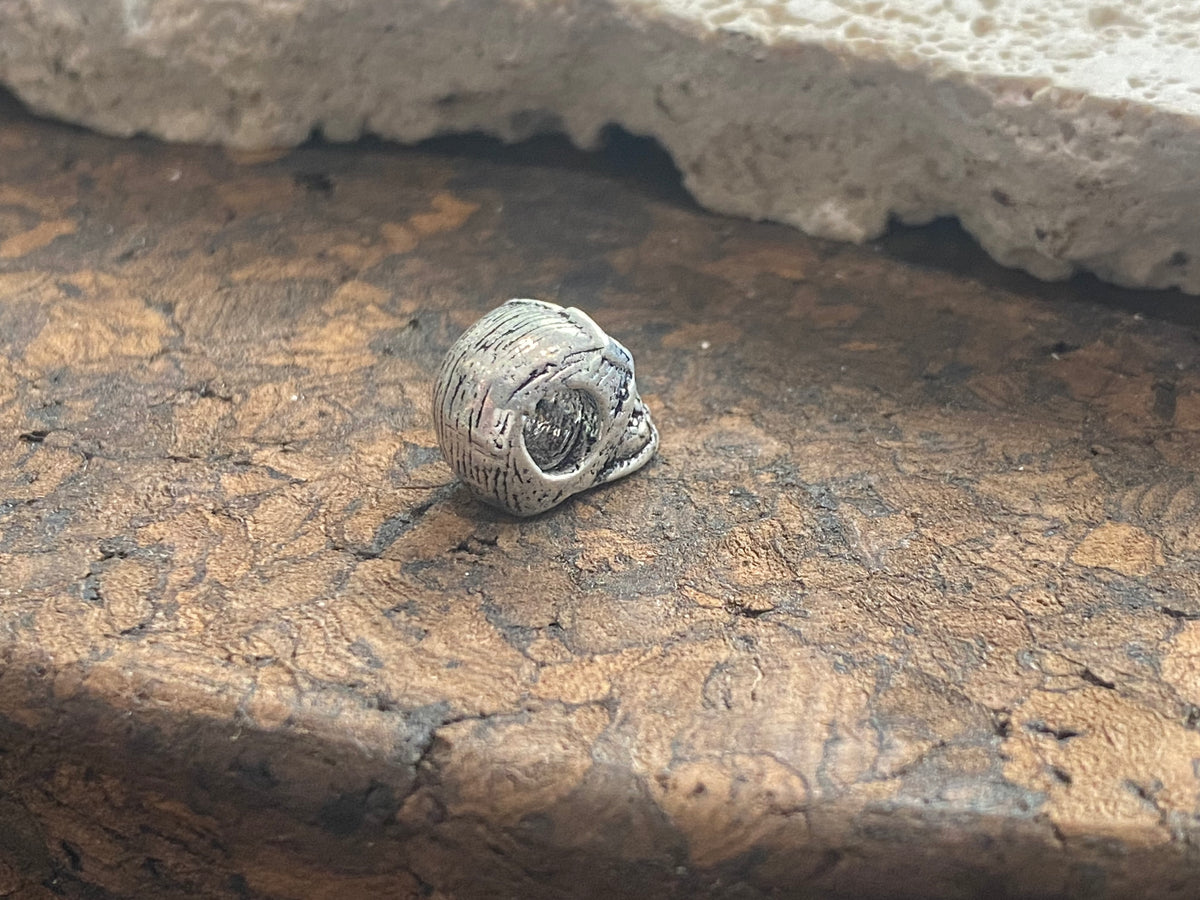 Sterling silver skull charm or pendant. Length 1 cm