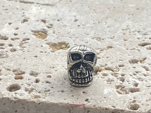 Sterling silver skull charm or pendant. Length 1 cm