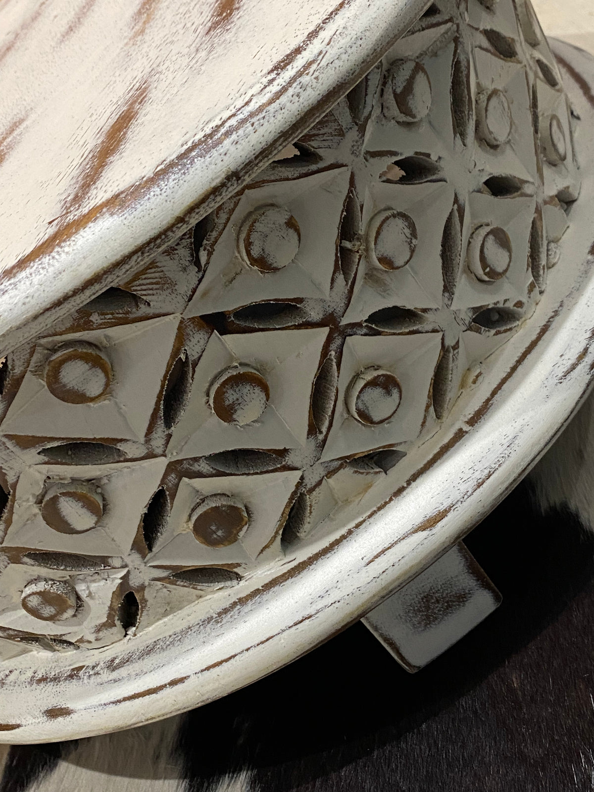 <p>Delightful, full wood small table with carved and pierced sides. Mango wood. Small enough to be used as a low bedside table, side table, pedestal or even on a table top.</p> <p>Measurements: diameter 44 cm, height 21.5 cm</p>