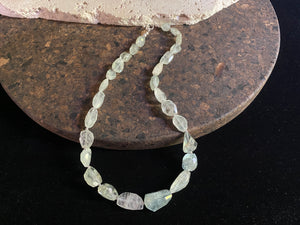 Natural pale blue aquamarine bead necklace featuring a magnificent centre bead and tiny silver bead detailing. Sterling silver findings. The aquamarine beads are matched, graduated, 100% natural and facet cut. They are a very light blue with a colour that changes depending on the angle viewed. 44.5 cm length