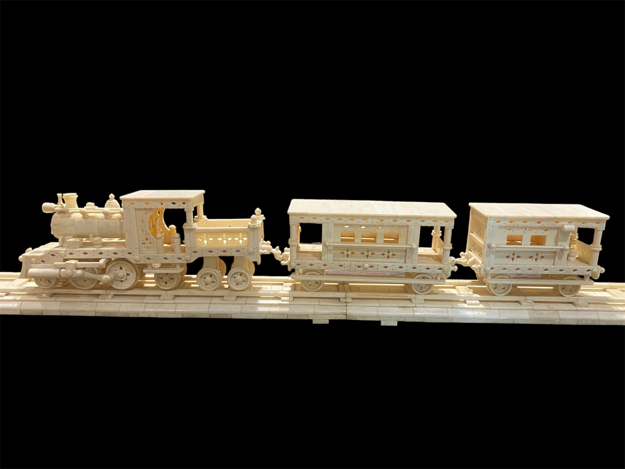 Large vintage train set handcrafted from finely shaped panels of camel bone. Northern India. Circa 1980. The set consists of four pieces: the track measuring 1.2 metres in length, the engine carriage with working pistons, the passenger carriage and the engineer's carriage.