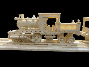 Large vintage train set handcrafted from finely shaped panels of camel bone. Northern India. Circa 1980. The set consists of four pieces: the track measuring 1.2 metres in length, the engine carriage with working pistons, the passenger carriage and the engineer's carriage.