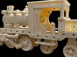 Large vintage train set handcrafted from finely shaped panels of camel bone. Northern India. Circa 1980. The set consists of four pieces: the track measuring 1.2 metres in length, the engine carriage with working pistons, the passenger carriage and the engineer's carriage.