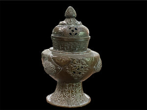 Handmade large incense burner. Pierced & footed pot with lid and inner tin to hold incense. Topped with lotus bud, ringed with viswa vajras, lotus buds, cloud spandrels and a frieze of swastikas. Hand beaten copper, mid 20th century. Collected by Bernard Heaphy in a village near Mount Everest. 31 cm h x 17 cm diameter