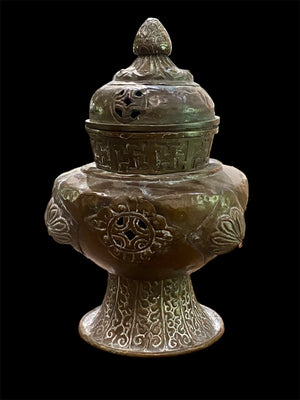 Handmade large incense burner. Pierced & footed pot with lid and inner tin to hold incense. Topped with lotus bud, ringed with viswa vajras, lotus buds, cloud spandrels and a frieze of swastikas. Hand beaten copper, mid 20th century. Collected by Bernard Heaphy in a village near Mount Everest. 31 cm h x 17 cm diameter