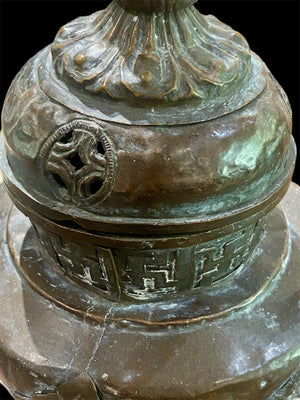 Handmade large incense burner. Pierced & footed pot with lid and inner tin to hold incense. Topped with lotus bud, ringed with viswa vajras, lotus buds, cloud spandrels and a frieze of swastikas. Hand beaten copper, mid 20th century. Collected by Bernard Heaphy in a village near Mount Everest. 31 cm h x 17 cm diameter