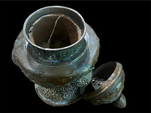 Handmade large incense burner. Pierced & footed pot with lid and inner tin to hold incense. Topped with lotus bud, ringed with viswa vajras, lotus buds, cloud spandrels and a frieze of swastikas. Hand beaten copper, mid 20th century. Collected by Bernard Heaphy in a village near Mount Everest. 31 cm h x 17 cm diameter