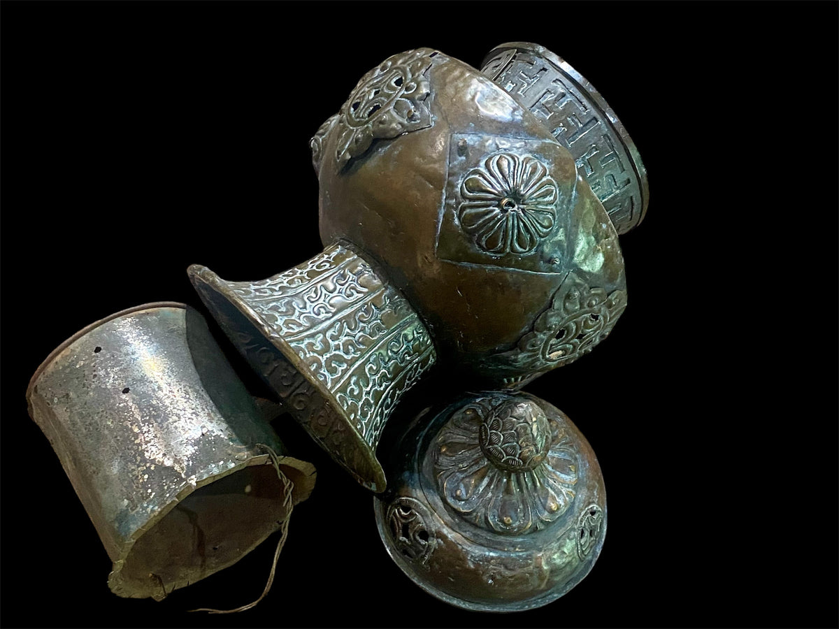 Handmade large incense burner. Pierced & footed pot with lid and inner tin to hold incense. Topped with lotus bud, ringed with viswa vajras, lotus buds, cloud spandrels and a frieze of swastikas. Hand beaten copper, mid 20th century. Collected by Bernard Heaphy in a village near Mount Everest. 31 cm h x 17 cm diameter