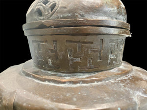 Handmade large incense burner. Pierced & footed pot with lid and inner tin to hold incense. Topped with lotus bud, ringed with viswa vajras, lotus buds, cloud spandrels and a frieze of swastikas. Hand beaten copper, mid 20th century. Collected by Bernard Heaphy in a village near Mount Everest. 31 cm h x 17 cm diameter