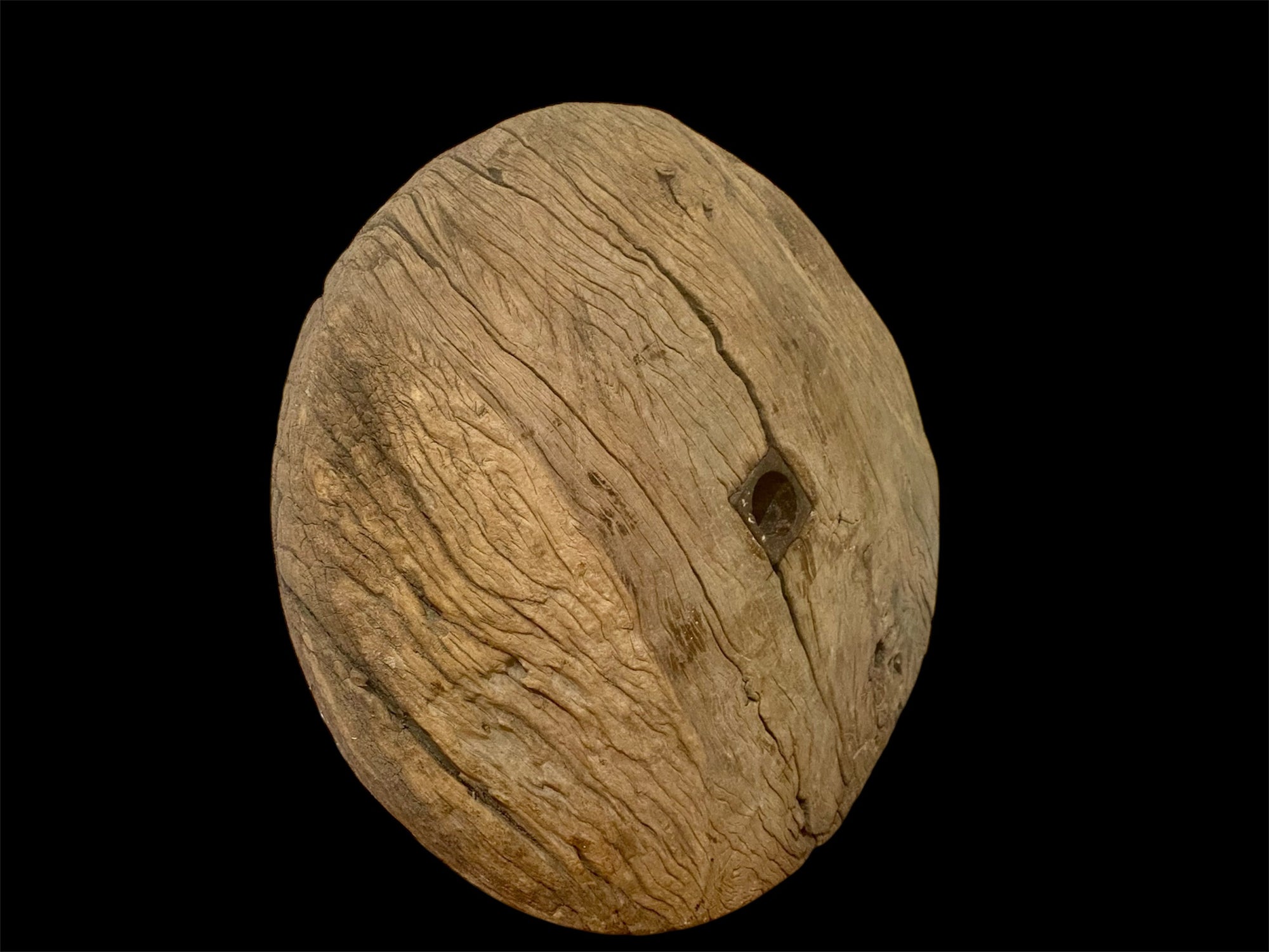 Antique solid teak wood cart wheel, rural India, early 20th century. Natural age and texture, central iron spoke hole and staples. Diameter 73 cm, depth 20 cm