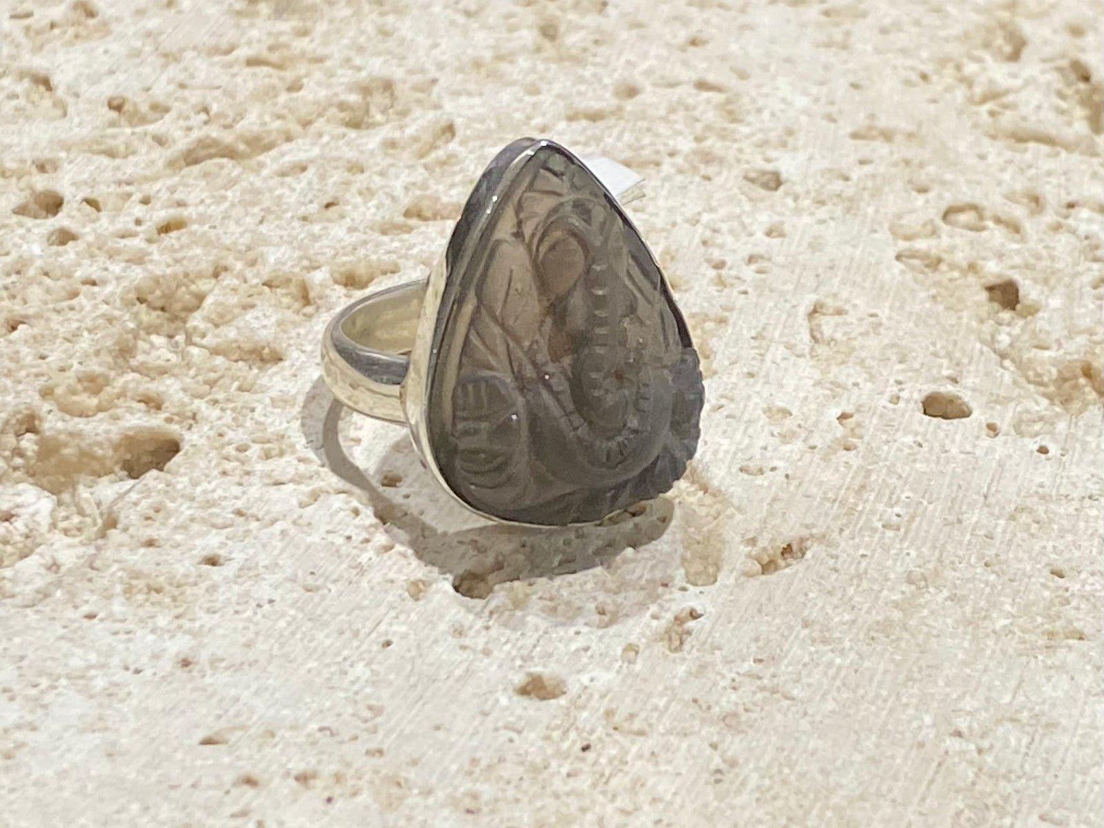 Hand carved smokey quartz ring featuring an image of Ganesh, set in sterling silver. Stone length 2.1 cm, width 1.6 cm, US Size 7 | Inside diameter 17.5 mm