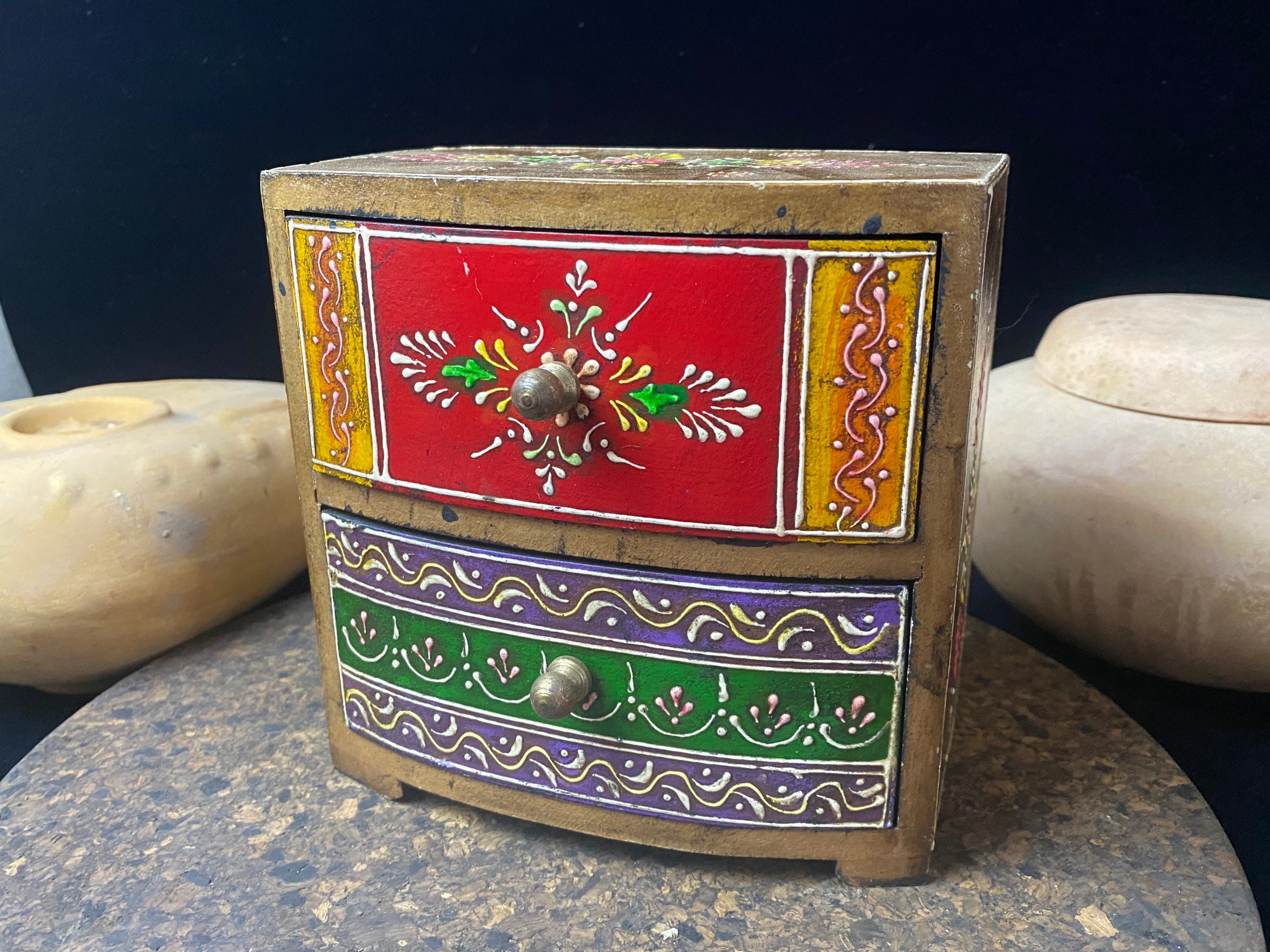 Vibrant hand painted trinket box with two drawers. Small brass knobs as handles. Perfect decorated box to keep trinkets in. Its large roomy drwers makes this a great box to hold small essential oils or jewellery.  From Rajasthan, India.  Measurements: 15 x 8.5 cm, height 15 cm