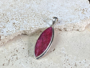 Natural ruby pendants featuring large facet cut stones set in sterling silver. All are set with generous bails to fit on even the largest of chains, torcs or cords. Ranging in length from 6 cm to 2.5 cm