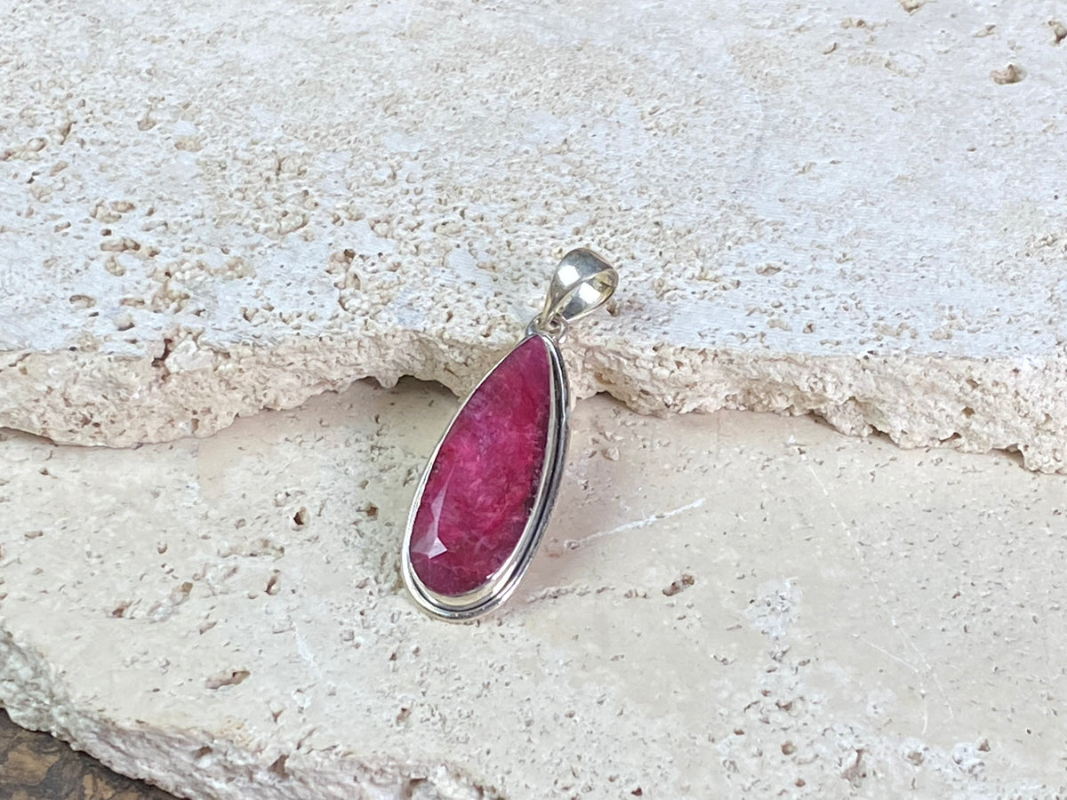 Natural ruby pendants featuring large facet cut stones set in sterling silver. All are set with generous bails to fit on even the largest of chains, torcs or cords. Ranging in length from 6 cm to 2.5 cm