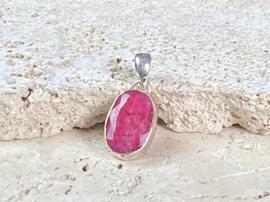 Natural ruby pendants featuring large facet cut stones set in sterling silver. All are set with generous bails to fit on even the largest of chains, torcs or cords. Ranging in length from 6 cm to 2.5 cm