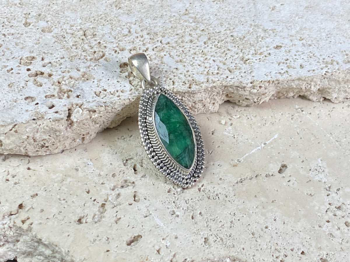 Six lush natural emerald pendants featuring large facet cut stones set in sterling silver. All are set with generous bails to fit on even the largest of chains, torcs or cords. Ranging in length from 6 cm to 2.8 cm