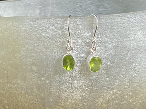 Beautiful peridot earrings featuring gem quality facet cut peridot stones in three shapes, teardrop, oval or leaf. A sterling silver mount and hook completes the look. These earrings are open at the back to allow light to shine through the stones. Around 3 cm length including hook