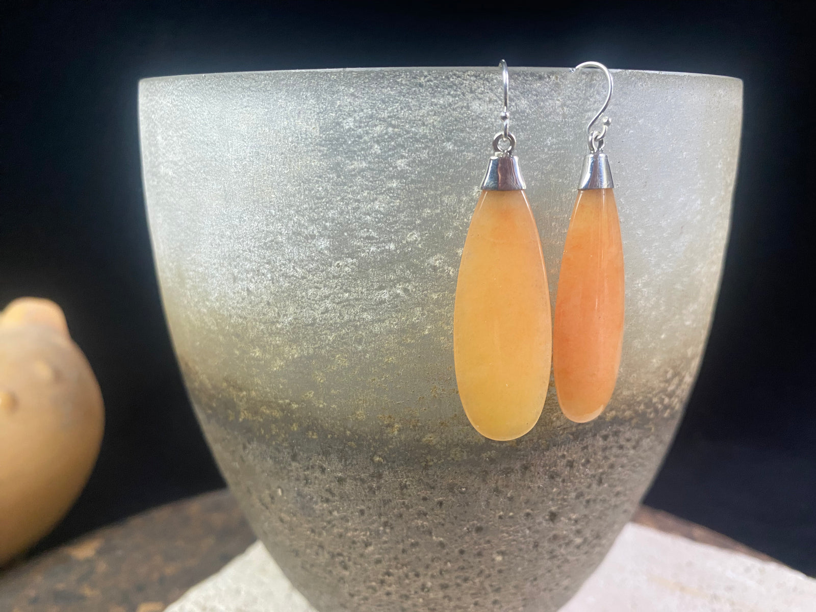 Translucent orange flat teardrop jade earrings set in stylish sterling silver mounts and hooks. Lightweight and easy to wear. 5 cm length including hook, width 1.2 cm at widest point 