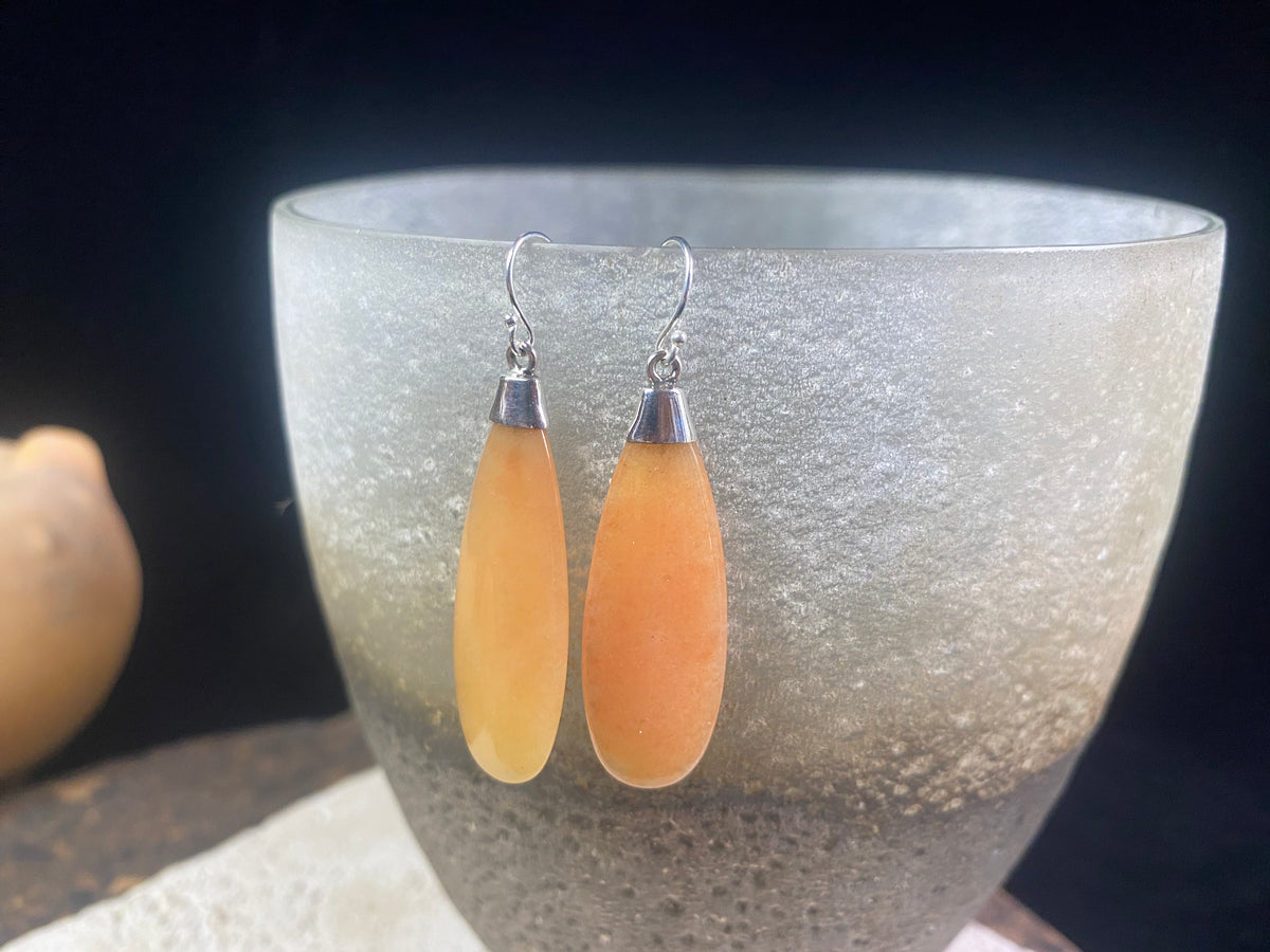 Translucent orange flat teardrop jade earrings set in stylish sterling silver mounts and hooks. Lightweight and easy to wear. 5 cm length including hook, width 1.2 cm at widest point 