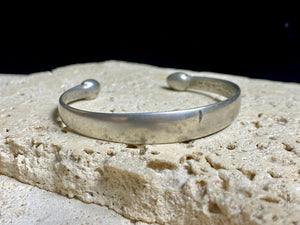 Indian antique silver bracelets, most likely made originally to be worn as a pair. These date to the early 1900's. They display a lovely worn and aged patina and test out at 80% silver. Measurements: height at front 1 cm