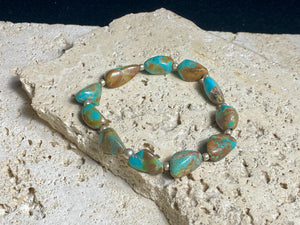 Natural Tibetan turquoise bracelet finished with sterling silver beads. Strong on sturdy elastic for a seamless look. Measurements: length 19 cm (7.5")
