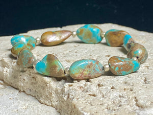 Natural Tibetan turquoise bracelet finished with sterling silver beads. Strong on sturdy elastic for a seamless look. Measurements: length 19 cm (7.5")
