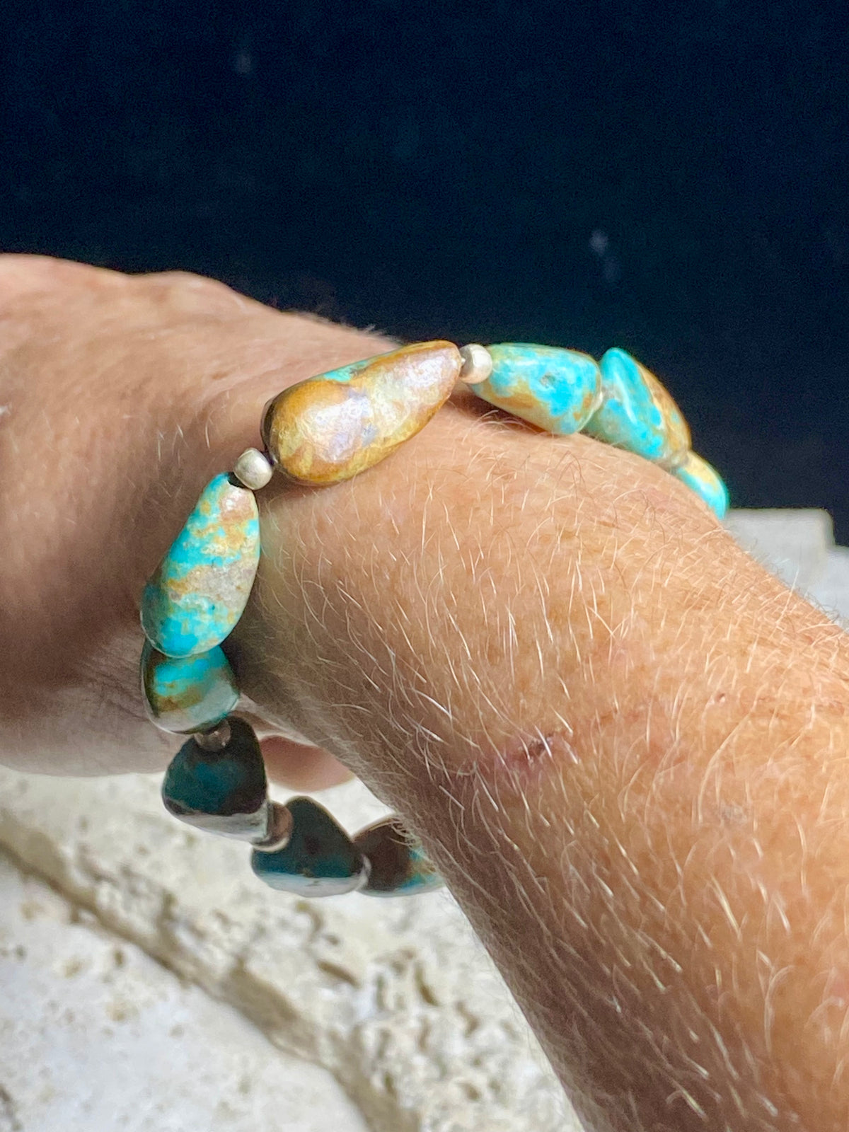 Natural Tibetan turquoise bracelet finished with sterling silver beads. Strong on sturdy elastic for a seamless look. Measurements: length 19 cm (7.5")
