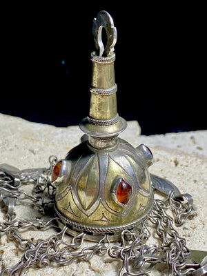 Tekke Turkoman women's cap jewellery.&nbsp; High grade silver, 24k gold fire gilding, finished with four carnelian stones.All dangles are intact. Mid 20th Century. This would have once endowed the headdress of a Turkoman girl. Measurements: total height including dangles 18 cm (6.5"). Diameter at base 5 cm (1.5"). Height of body (without dangles) 8.5 cm