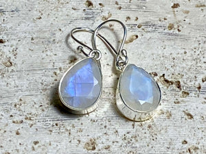 Our stunning, classic teardrop earrings feature high quality, large facet cut teardrop rainbow moonstone stones set in a simple sterling silver bezel.

Measurements: 3 cm (1.35”) length including hook&nbsp;