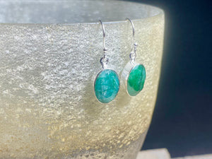 These precious emeralds and ruby stone earrings are facet cut to show off the natural liquid beauty of the stones. All finished with simple sterling silver settings to show off the beauty of the stones. Measurements: height approximately 3.5 cm including hook, depth of setting 0.5 cm