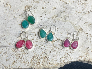 These precious emeralds and ruby stone earrings are facet cut to show off the natural liquid beauty of the stones. All finished with simple sterling silver settings to show off the beauty of the stones. Measurements: height approximately 3.5 cm including hook, depth of setting 0.5 cm