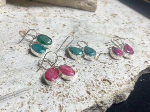 These precious emeralds and ruby stone earrings are facet cut to show off the natural liquid beauty of the stones. All finished with simple sterling silver settings to show off the beauty of the stones. Measurements: height approximately 3.5 cm including hook, depth of setting 0.5 cm