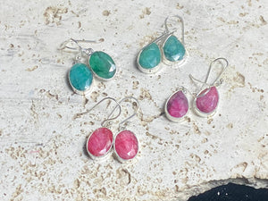 These precious emeralds and ruby stone earrings are facet cut to show off the natural liquid beauty of the stones. All finished with simple sterling silver settings to show off the beauty of the stones. Measurements: height approximately 3.5 cm including hook, depth of setting 0.5 cm