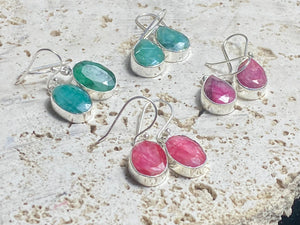 These precious emeralds and ruby stone earrings are facet cut to show off the natural liquid beauty of the stones. All finished with simple sterling silver settings to show off the beauty of the stones. Measurements: height approximately 3.5 cm including hook, depth of setting 0.5 cm