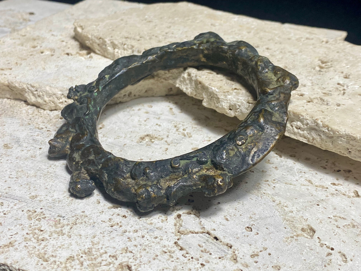 Antique Bronze Dông Son bracelet, Vietnam. Solid cast bronze bangle featuring an array of animals. Inside diameter 25 cm. Height 1.3 cm.
