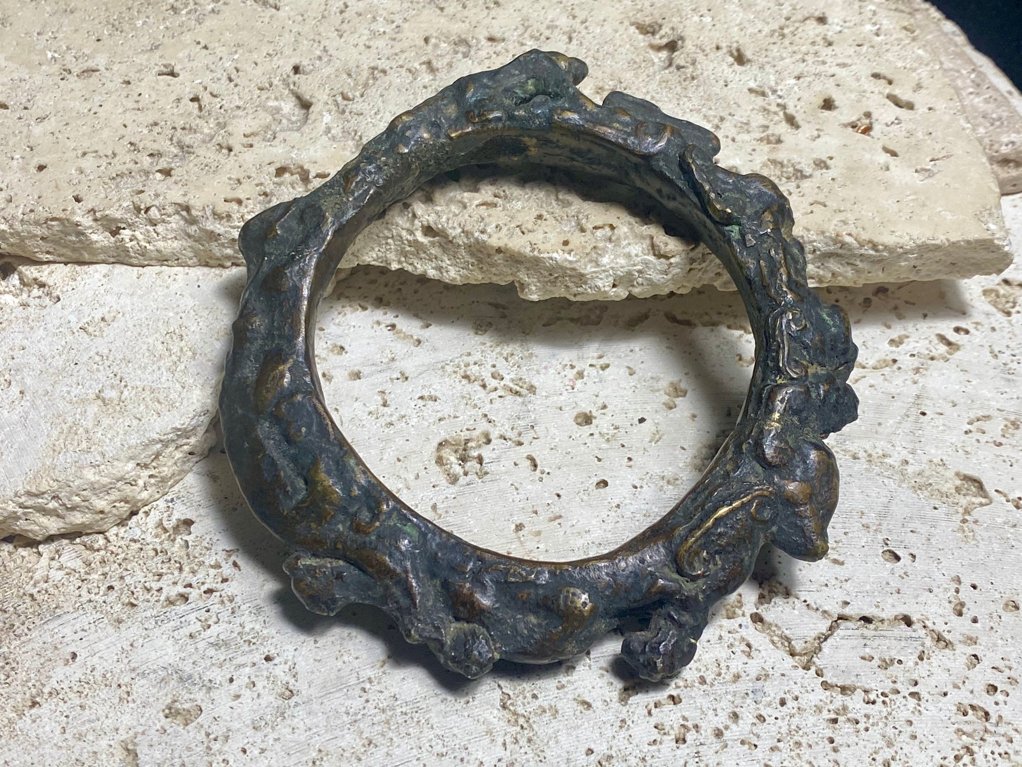 Antique Bronze Dông Son bracelet, Vietnam. Solid cast bronze bangle featuring an array of animals. Inside diameter 25 cm. Height 1.3 cm.
