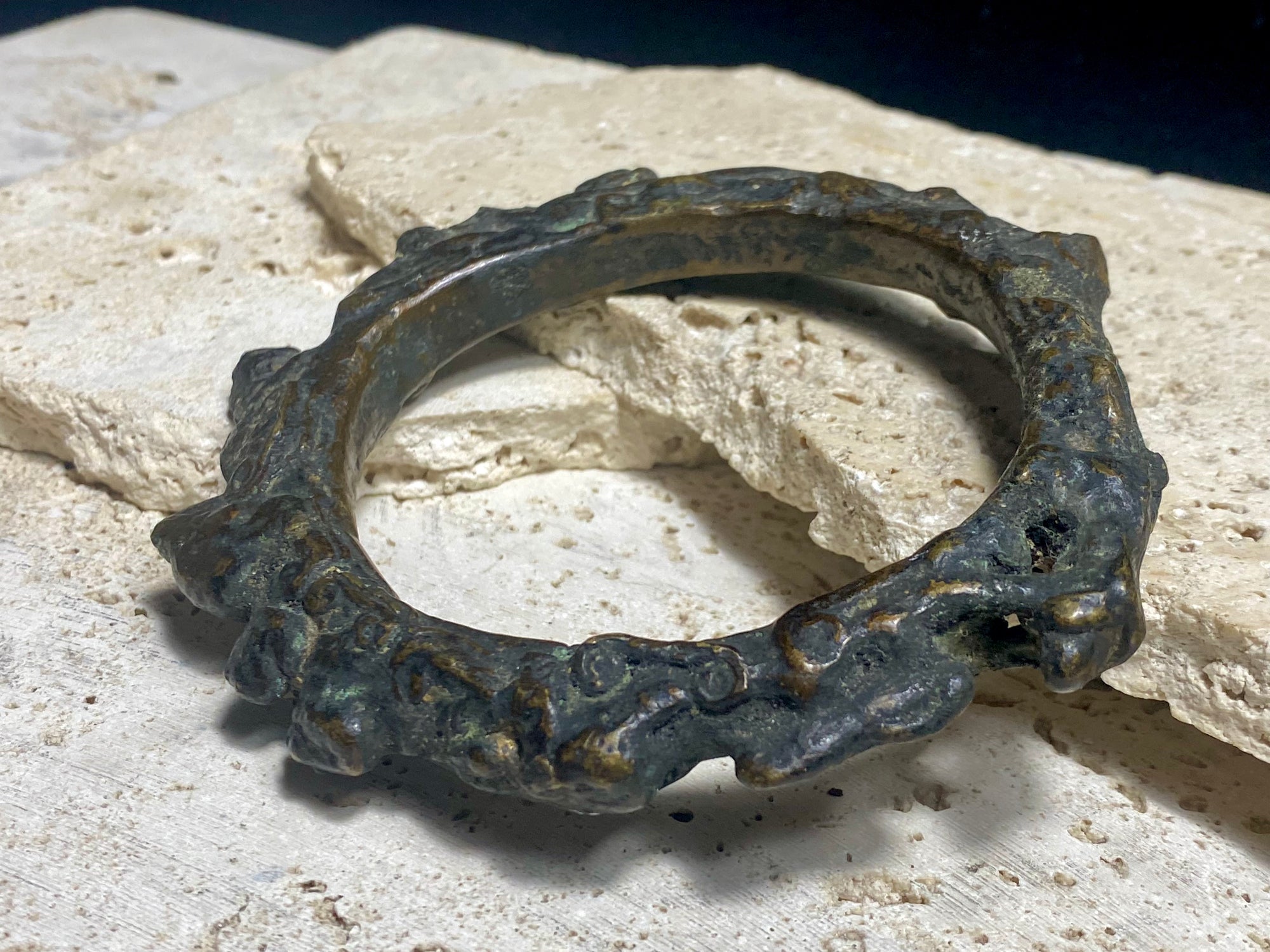 Antique Bronze Dông Son bracelet, Vietnam. Solid cast bronze bangle featuring an array of animals. Inside diameter 25 cm. Height 1.3 cm.
