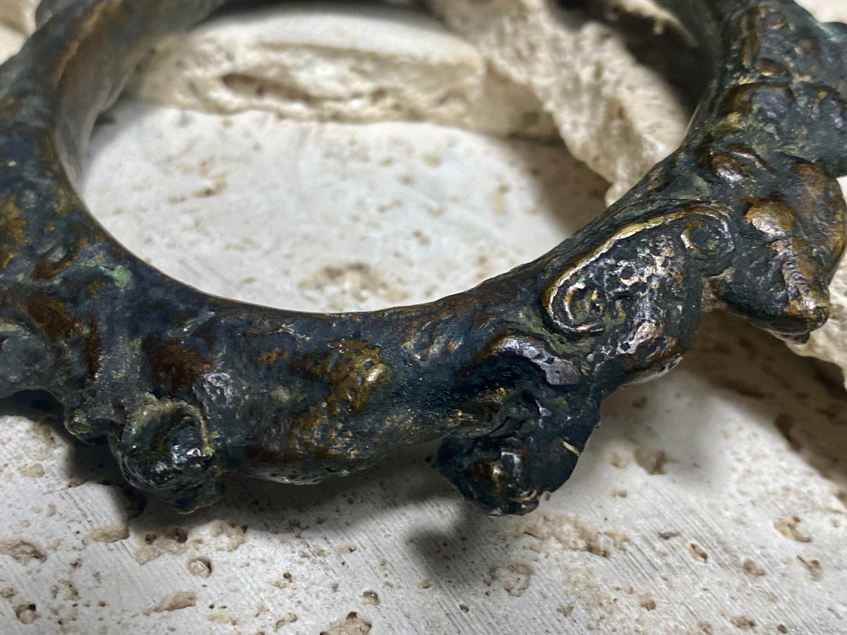 Antique Bronze Dông Son bracelet, Vietnam. Solid cast bronze bangle featuring an array of animals. Inside diameter 25 cm. Height 1.3 cm.
