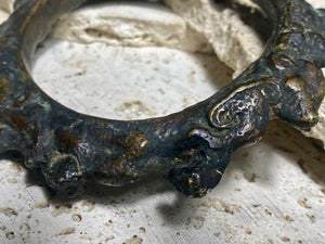 Antique Bronze Dông Son bracelet, Vietnam. Solid cast bronze bangle featuring an array of animals. Inside diameter 25 cm. Height 1.3 cm.
