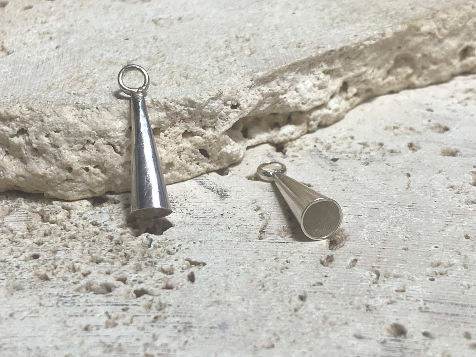 Strong and long elegant silver cone ends. Perfect for finishing multi strand necklaces. Long enough to hold single tapered stones with absolute confidence. Lght enough to be incorporated into earring projects.Sterling silver. Length 2.2 cm
