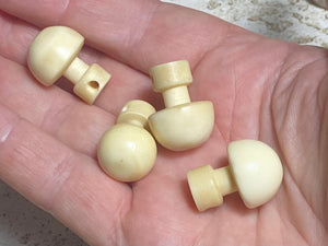 Large domed bone buttons, hand carved from buffalo bone. From Burma. Length 22 cm, diameter1.6 cm