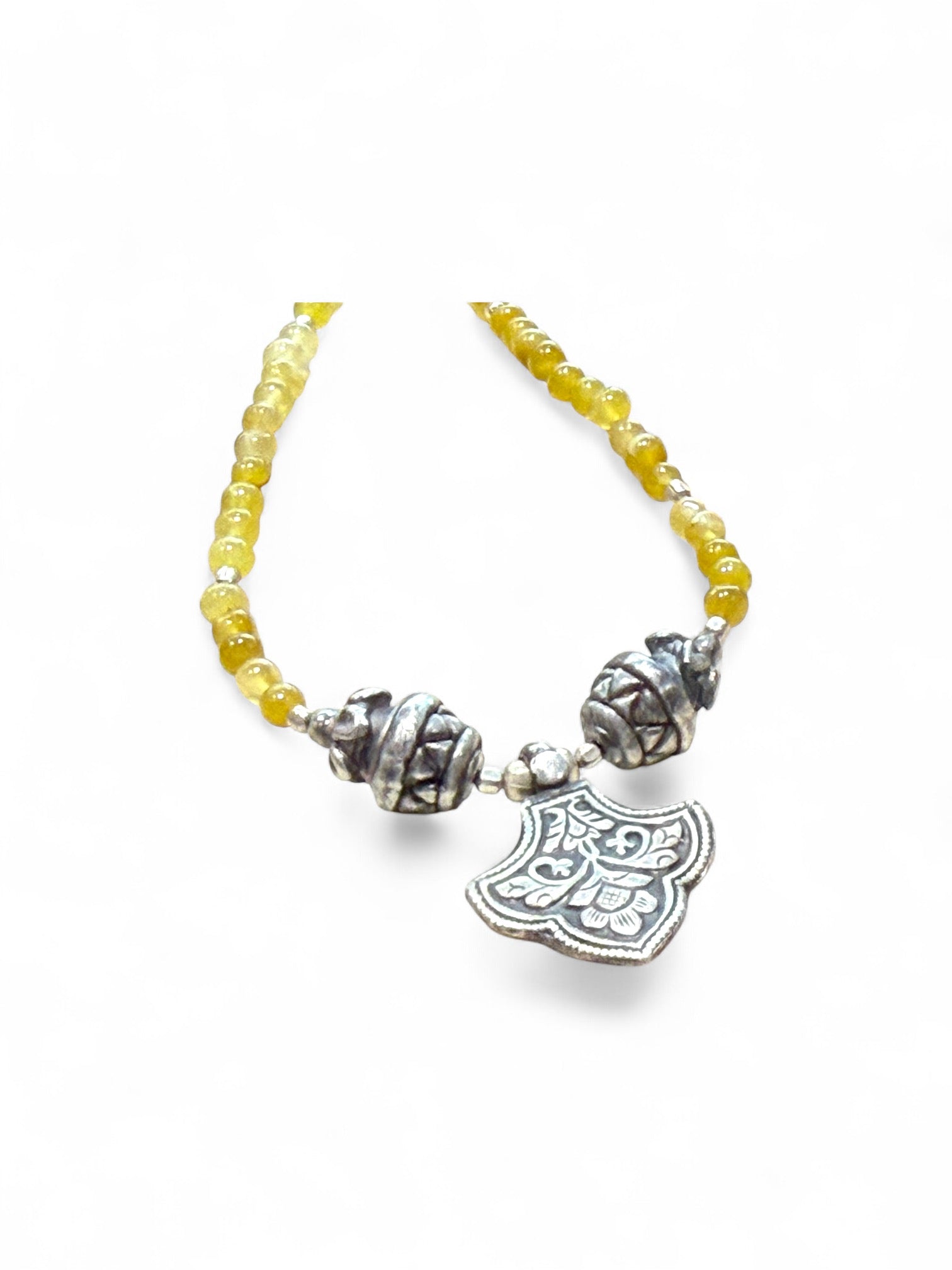 Short choker necklace of yellow jade, handmade Indian vintage silver art deco 'pineapple" beads and a centre silver pendant. 39 cm length