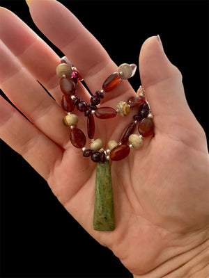 Statement necklace features a jade pendant with jasper, buffalo horn and red garnet beads, highlighted with silver beads & clasp. Length 47.5 cm, pendant 4.6 cm