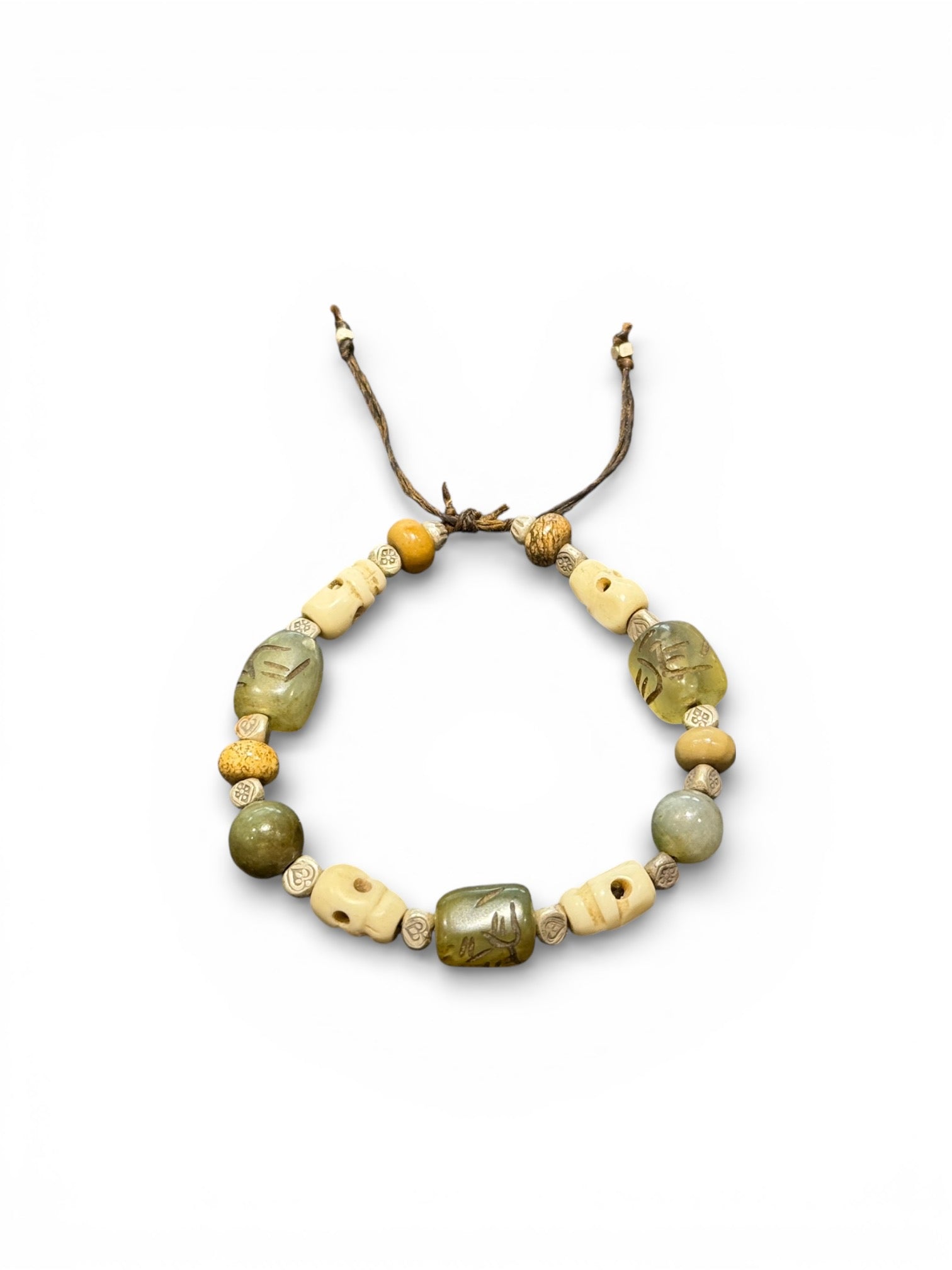 Heavy bracelet of carved yak bone, jasper, vintage Tibetan jade and Karen hill tribe silver. On waxed cord, adjustable, unisex. Length 18.5 cm, size 17 cm