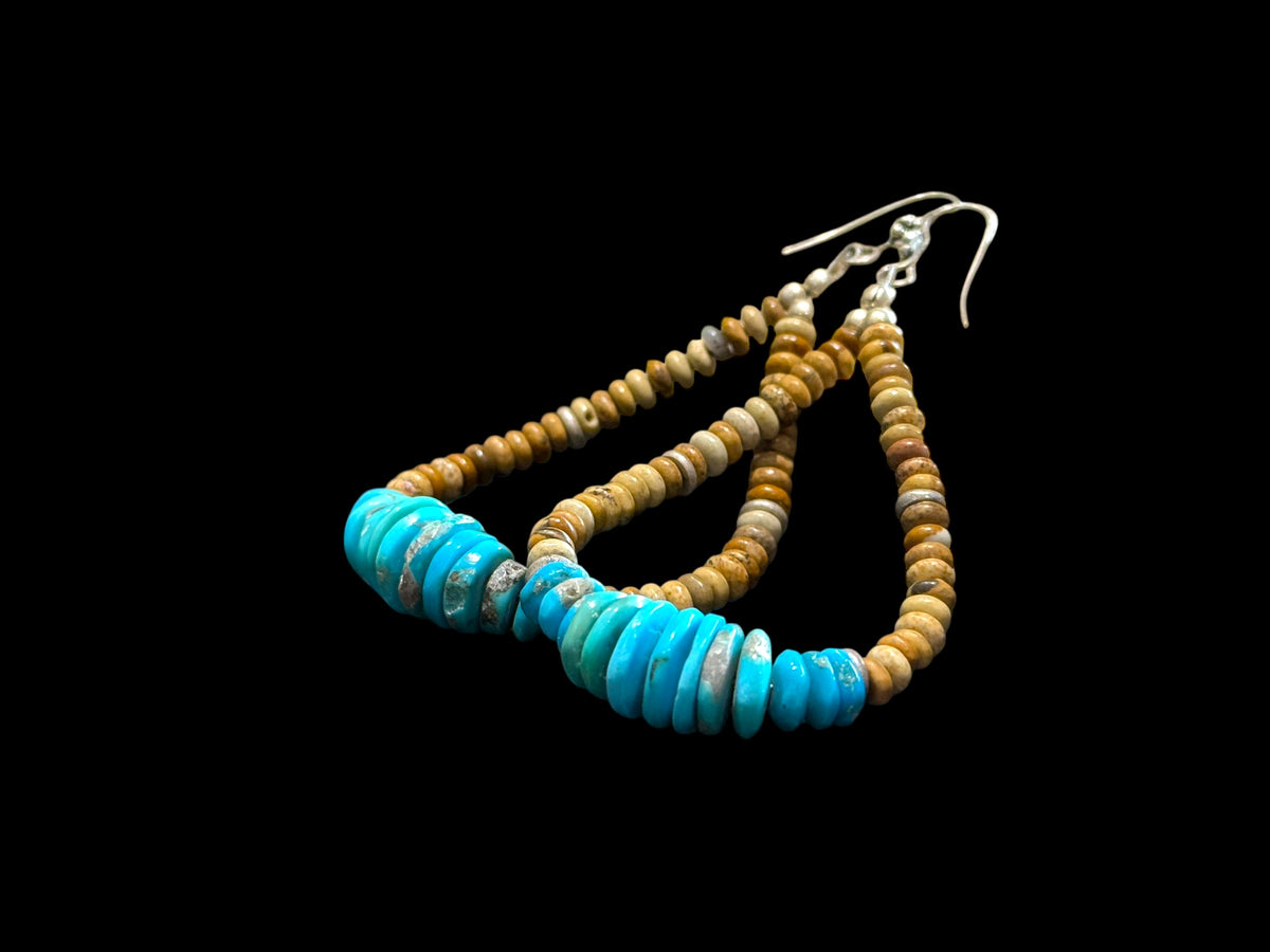 Long and beautiful graduated natural Arizonian turquoise with rondel cut jasper beads. The earrings are finished with sterling silver. Length 9 cm
