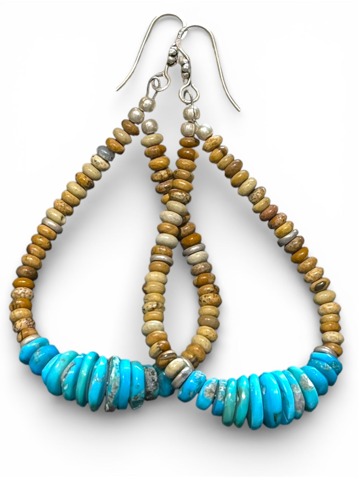 Long and beautiful graduated natural Arizonian turquoise with rondel cut jasper beads. The earrings are finished with sterling silver. Length 9 cm