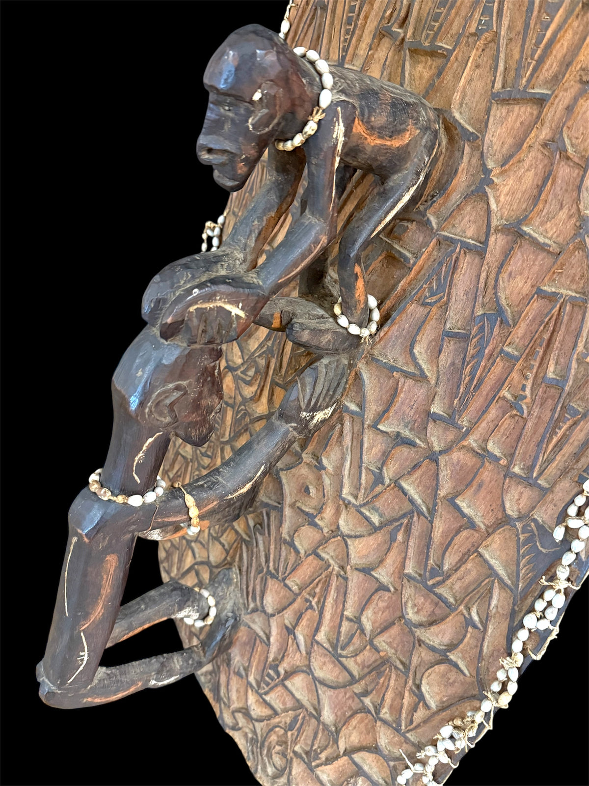 Asmat jungle hardwood shield. Wood carved and decorated with lime, ochre, charcoal, and shell beading. Central Asmat region, Irian Jaya (Indonesian Papua). Measurements: 104 cm x 39 cm, depth 17 cm