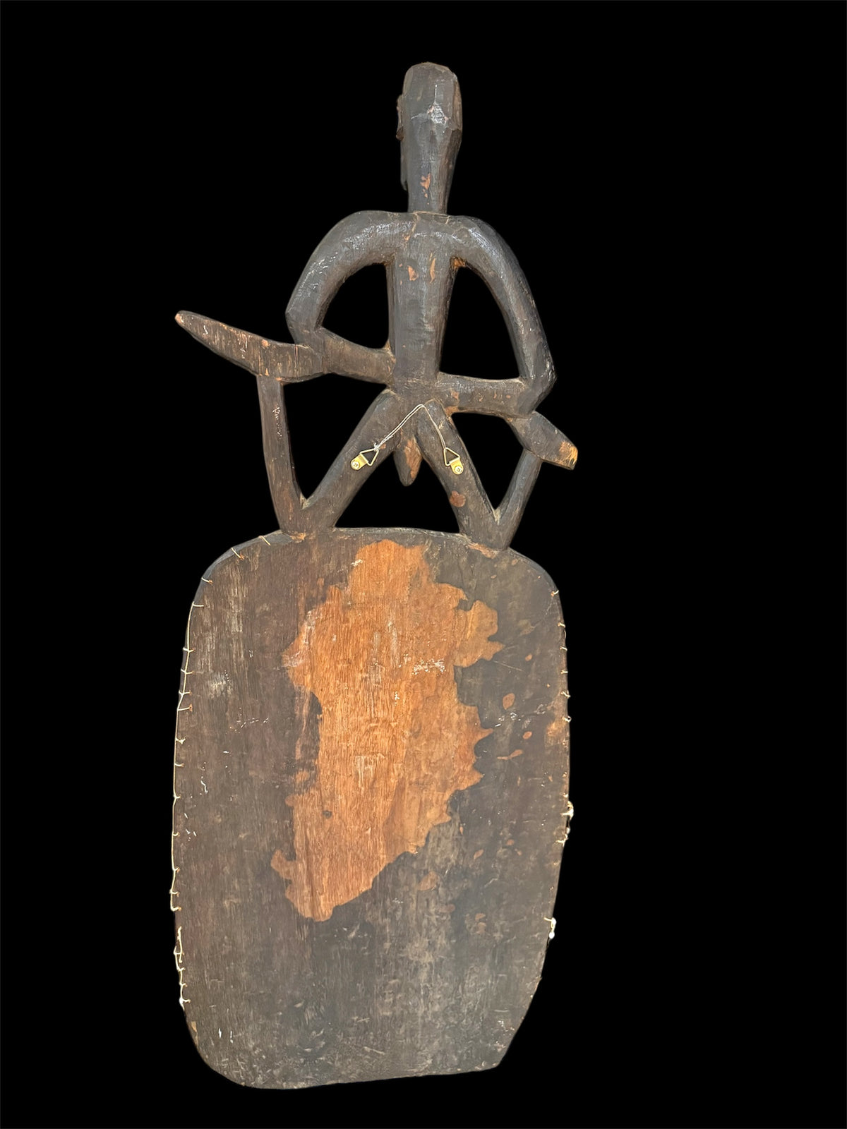 Asmat jungle hardwood shield. Wood carved and decorated with lime, ochre, charcoal, and shell beading. Central Asmat region, Irian Jaya (Indonesian Papua). Measurements: 104 cm x 39 cm, depth 17 cm