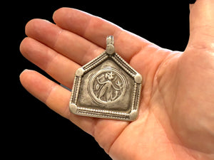 Antique Indian amulet depicting Durga in her Kali Maa form. High grade silver. Early 20th century or earlier. Height 5.3 cm including bail, width 4.5 cm